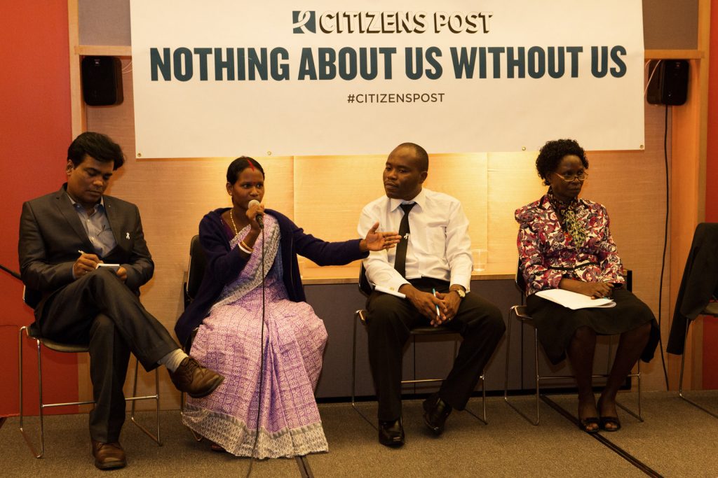 Panellists seating in front of a banner that reads: Citizen Post, Nothing about us without us